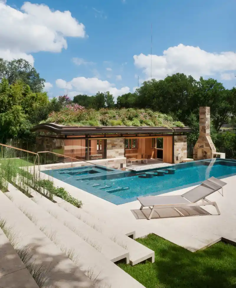 Existing swimming pool with curved coping and surrounding deck for remodeling inspiration
